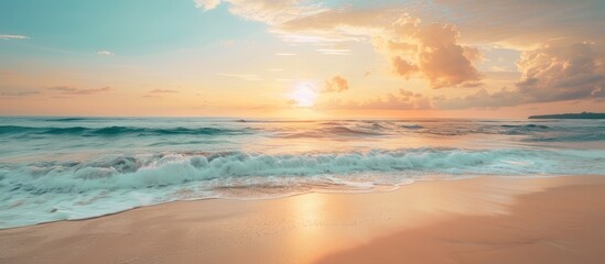 Poster - Sunrise or sunset sky over a tropical beach with a beautiful beach setting in summer suitable for copy space image