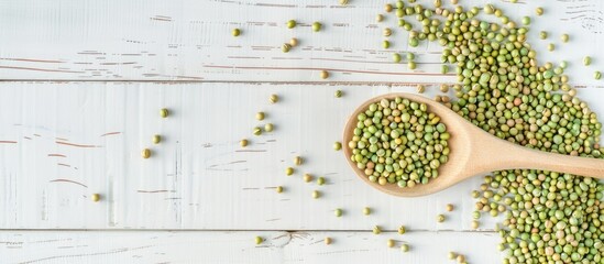 Poster - Top down view of raw green buckwheat grains in a spoon on a white wooden surface with room for text Additional copy space image available