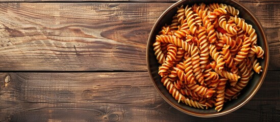 Aufkleber - Top view of a vegetarian Italian dish on the menu concept featuring rotini pasta in tomato sauce with a background suitable for text in a copy space image