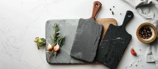 Poster - Top view of slate cooking boards on a white surface with space for text ideal for a copy space image mockup