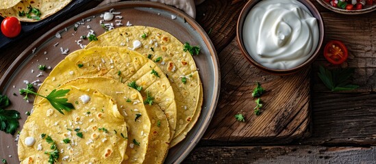 Poster - Low carb gluten free tortillas made from coconut flour and psyllium husk topped with cream and veggies displayed on a cutting board and plate on a wooden table with copy space image