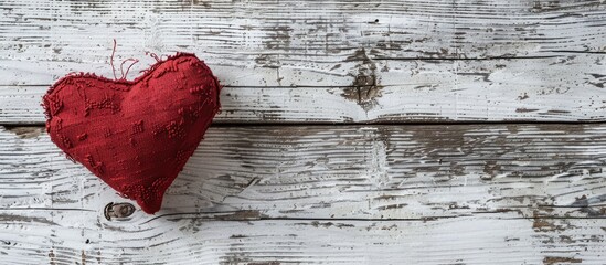 Aufkleber - A red heart shaped cushion close up on weathered white wood with copy space image for Valentine s background symbolizing the concept of love