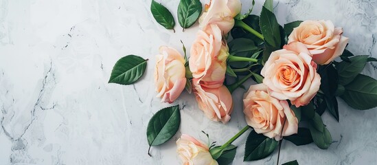 Poster - Flat lay scene captured from above featuring a rose bouquet with leaves on a light table providing ample copy space in the image