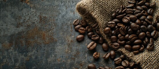 Poster - Close up flat lay of coffee beans resting on a rustic jute sack with ample copy space in the image
