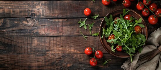 Poster - Wooden table with salad featuring arugula and cherry tomatoes with copy space image