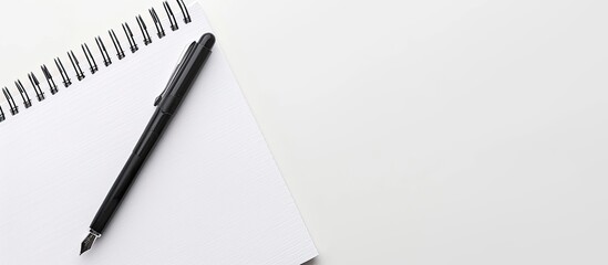 Fototapete - A classic pairing of a white notepad and a black pen perfect for taking notes or sketching creating a timeless look in a copy space image