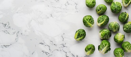 Poster - Flat lay of Brussels sprouts on a white marble surface with space for text in the image. copy space available