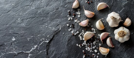 Wall Mural - A health conscious meal displayed on a stone or slate surface featuring garlic cloves and a bulb shot from above with ample copy space image