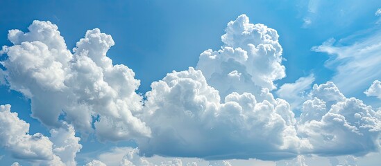 Poster - The expansive blue sky with fluffy clouds overhead creates a serene and peaceful copy space image