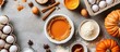 © Gular - A top down view of the ingredients for pumpkin pie including flour pumpkins eggs cane sugar spices and a white baking dish on a gray background with room for text or an image. copy space available