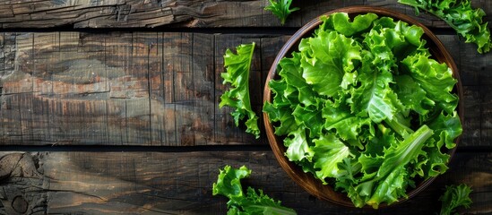 Poster - Top down view of a fresh green lettuce salad on a rustic wooden table Ideal for text placement Healthy dietary option with copy space image