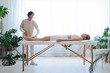 © Westend61 - Physiotherapist fixing senior woman foot lying on massage table at health spa