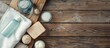 © StockKing - Top view of a spa kit on a wooden table with shampoo, soap bar, shower gel, towels, and copy space image.
