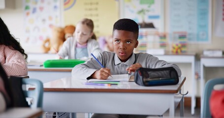Poster - Boy, child and writing notes in classroom for learning, knowledge and info for assessment. Kid, notebook and education with scholarship, studying and attention at lesson for development at school