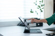 © Wasana - A woman is pointing at something on a laptop