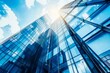 © 为轩 张 - Modern office building with blue sky and glass facade, depicting the concept of economy and finance from a bottom-up view, with a blurred background.