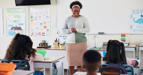 Canvas Print - Teacher, children and talking in classroom for lesson, advice or smile with assessment for development. Woman, child and quiz for education, info or knowledge for help, happy or scholarship at school