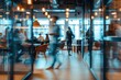 © julija - blurred open office space with employees collaborating soft focus on modern workstations and meeting areas