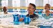 © peopleimages.com - Dumbbell, group and mature woman in swimming pool for exercise, healthy body and strong muscle. Aqua therapy, water and aerobics class for fitness, physiotherapy or rehabilitation of senior person