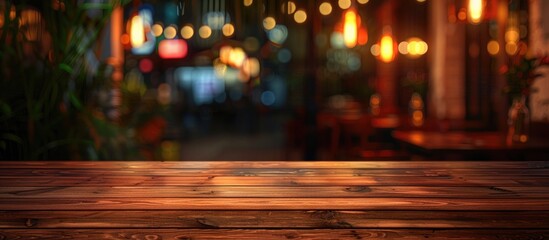 Sticker - An empty wooden table in the foreground contrasts against a blurred restaurant background at night offering an ideal spot for showcasing food with the vibrant night ambiance in the copy space image