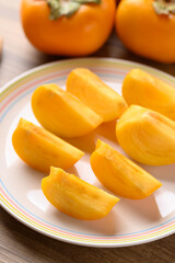 Wall Mural - Sliced ripe persimmon ready to eating, Autumn fruit