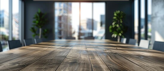 Canvas Print - Wooden table in an office setting showcasing an advertisement with a blurred modern meeting area as the copy space image