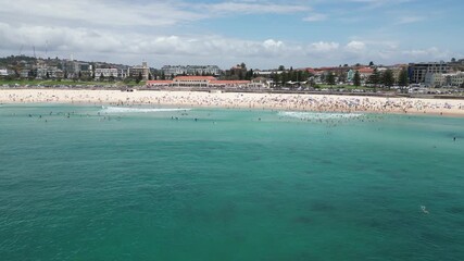 Wall Mural - Aerial footage of people enjoying their vacation on Bondi Beach on a sunny day in Sydney, Australia