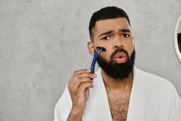 A man carefully shaves while reflecting in a mirror.