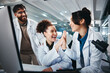 © peopleimages.com - Computer, scientist and women with success, medical research and celebration for results of test and man. Lab, online and conversation for medicine of healthcare, pharmaceutical and high five