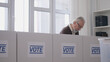 © Synthex🇺🇦 - Elderly man in a voting booth at a polling station, election day in a democratic country