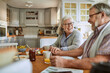 © Marko Geber - Happy senior couple eating breakfast in the kitchen