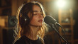 © ontsunan - Captivated by Sound, a young woman immersed in music, wearing headphones, lost in emotion while singing into a microphone in a cozy recording studio setting.