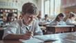 © inthasone - Happy schoolboy writing test during class in the classroom. with other students behind her, writing in a notebook and holding pencils.