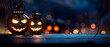 © john - Two halloween lanterns with evil eyes and face on a wood table with a spooky dark blue background at night with light bokeh.