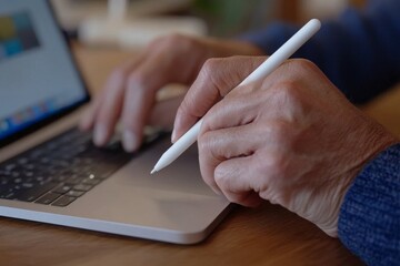 Poster - an office worker uses a laptop computer with a tablet computer on a table. her hand has been typing 