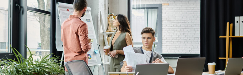 Wall Mural - Colleagues engage in discussions while in a stylish office setting.