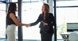 © peopleimages.com - Business people, women and meeting with handshake for partnership, collaboration and deal negotiation. Female employees, teamwork and thank you in office for b2b agreement, investor support and crm