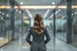 © Cloudyew - Corporate woman from behind in a professional environment.