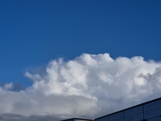 Wall Mural - Summer white fluffy cumulus clouds in the deep blue sky