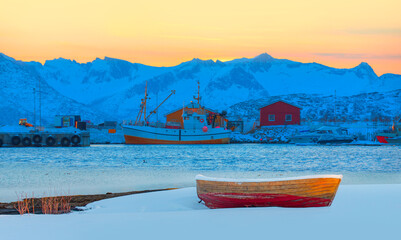 Wall Mural - red wooden boat covered with layers of snow - beautiful winter landscape with snow covered red house