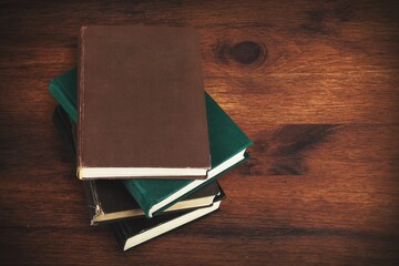 Canvas Print - Stack of old reading hardcover books on desk