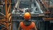© Nutthanon - Construction Worker Operating Crane at Industrial Site