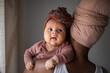 © Milles Studio/Stocksy - Black woman carrying baby at home