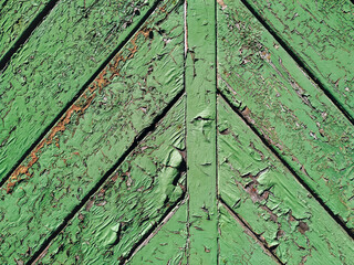 Wall Mural - Old green cracked paint on top of a wooden door. Texture and grunge background, diagonal orientation.