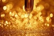 © Viam - Golden oil drop on glittering background with bokeh effect