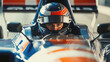 © Александр Довянский - Formula 1 driver in helmet sits behind the wheel of a car close-up and looks at the camera