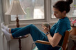 © tess Y/Stocksy - Nurse candid moment at home