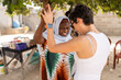 © Alvaro Lavin/Stocksy - Two women sharing a joyful moment while dancing in a senegalese market