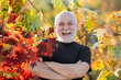 © Volodymyr - Funny excited senior man in Autumn leaves, gold and red leaves of autumn background. Senior with Maple leaves. grandfather in Colorful autumn leaves. Falling autumn. Funny old male face close up.