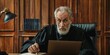 © Brian - Perplexed old man judge using laptop